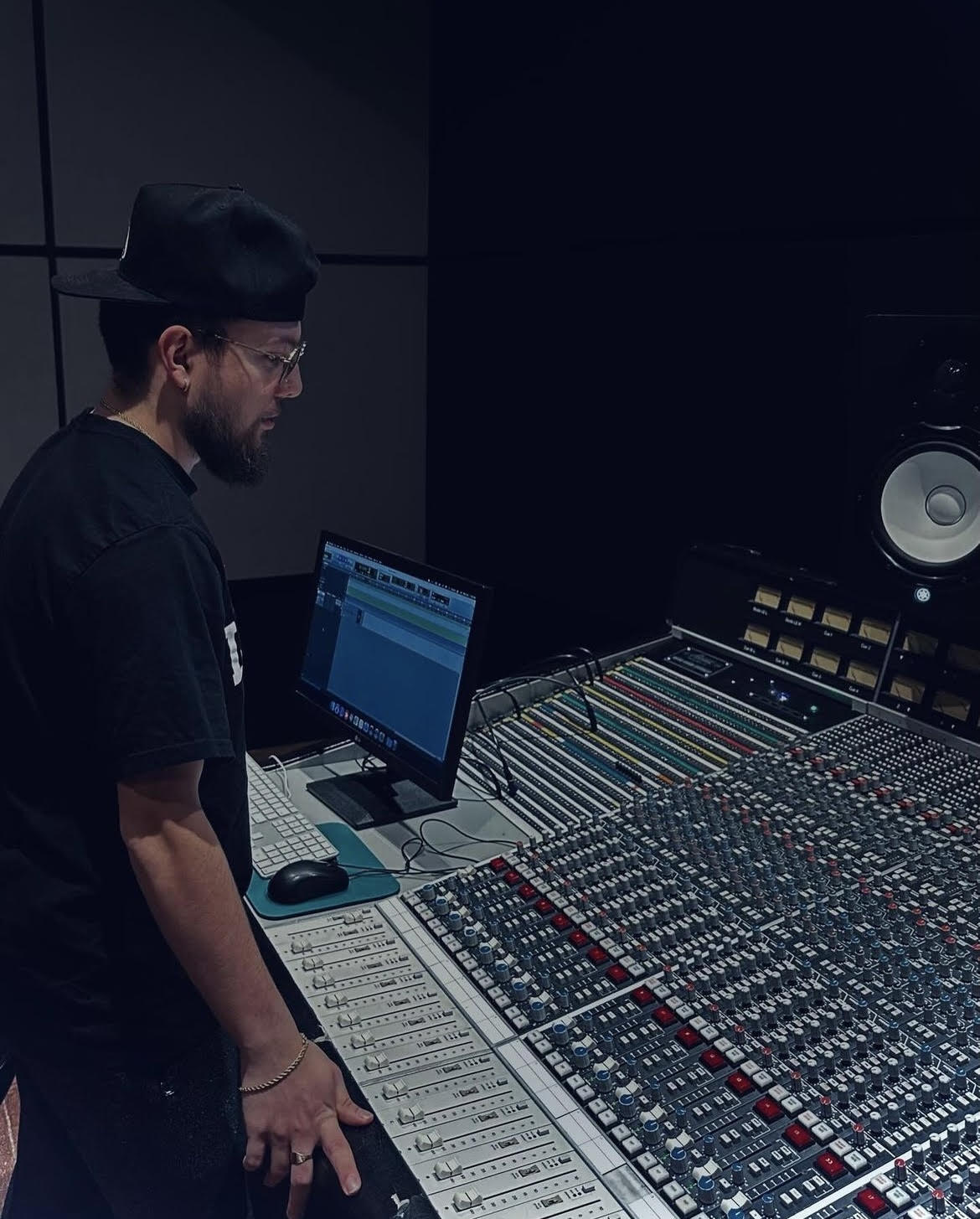 Austin Reis standing at a mixing console