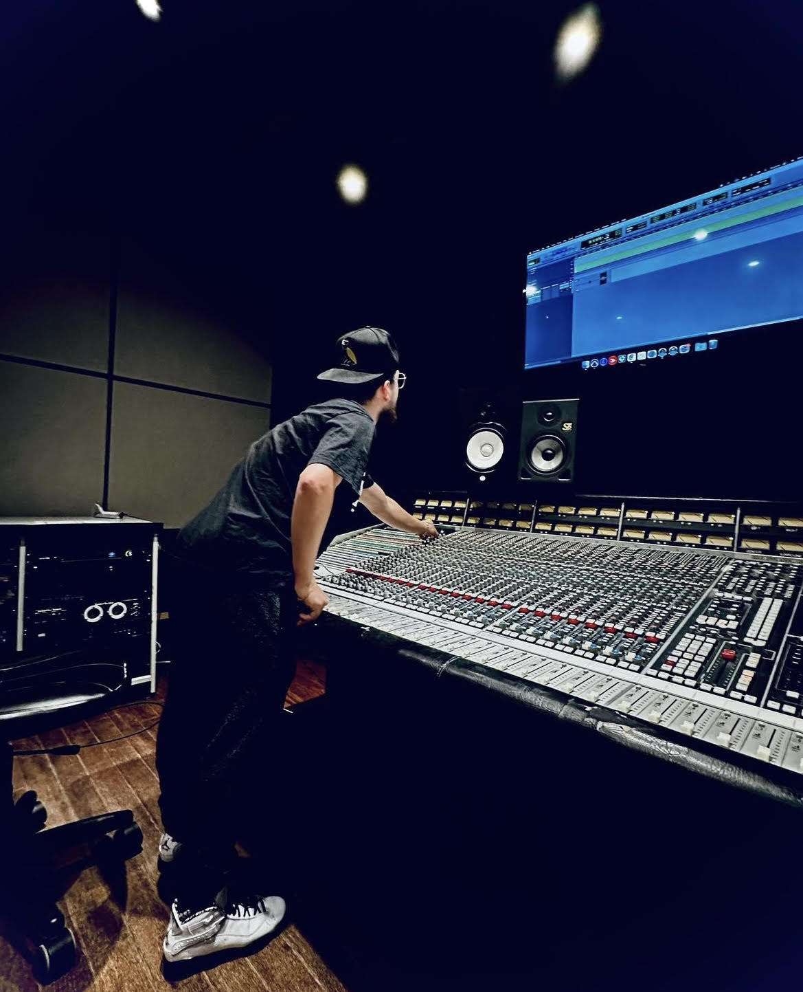 Austin Reis standing at a mixing console